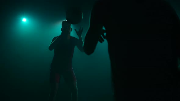 Silhouette of Athletes Who are Catching Ball and Dribbling Then Passing It Back alt
