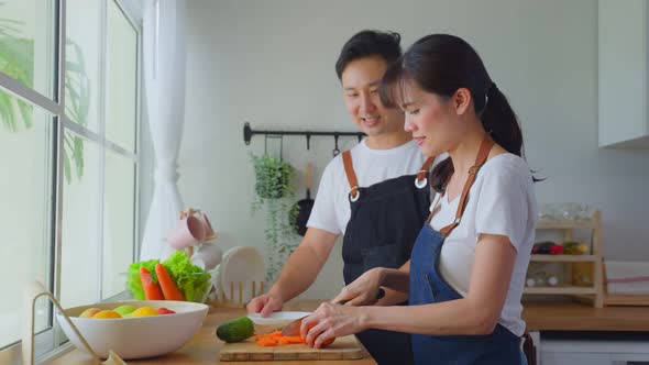 Asian happy family, new marriage couple prepare ingredient to cook foods in kitchen at house. alt