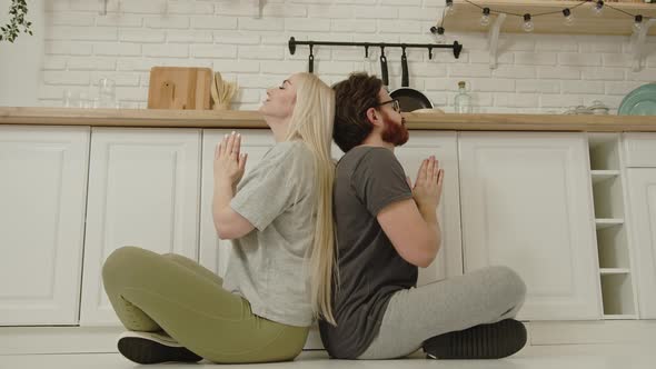 Back to Back Meditation Lotus Practiced By Longhaired Caucasian Woman and Her Boyfriend in Their alt