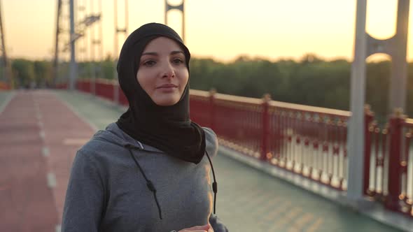 Lovely Muslim Female in Hijab Jogging Outdoors alt