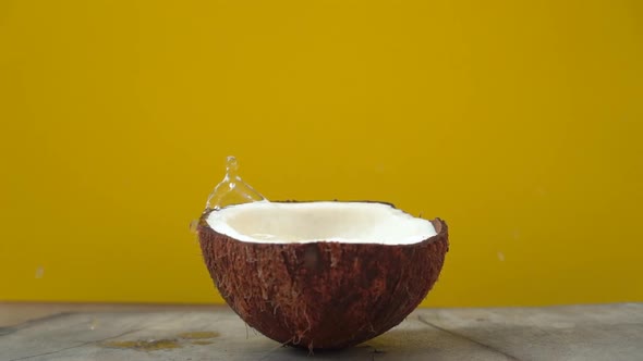 Superslowmotion Shot of Splashes of Coconut Milk After Cubes of Tropical Fruits Being Dropped in It alt