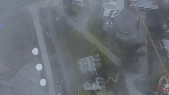 Stunning Aerial Footage Around the Mountains of Mount Bromo - Top view of winding roads with Foggy C alt