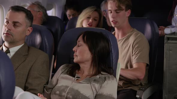 Woman trying to sleep on airplane flight