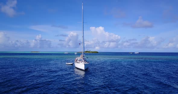 Wide angle fly over abstract shot of a sunshine white sandy paradise beach and blue ocean background alt
