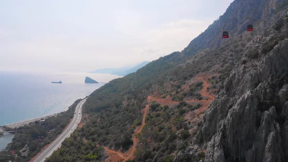 Close-up Flight Next To the Uphill Funicular with the Coast in the Background  alt