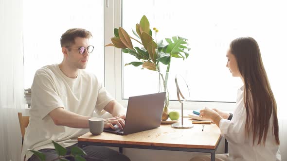 Beautiful Lady Do Make-up at Morning While Her Husband Work on Laptop. alt
