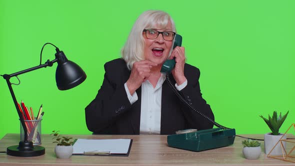 Senior Businesswoman Talking on Wired Vintage Telephone of 80s Says Hey you Call Me Back at Office alt