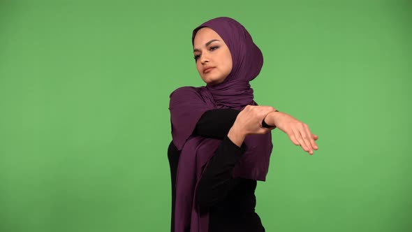 A Young Beautiful Muslim Woman Stretches  Green Screen Background