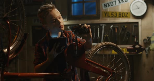 Teen Boy Repairs Bicycle alt