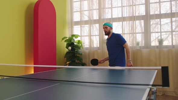 Good Looking Guy Playing on the Ping Pong Game He