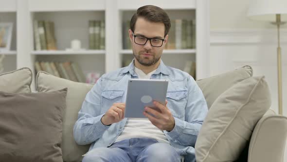 Young Man Using Tablet at Home alt