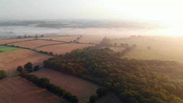 Aerial footageing left to right of fields at Lexden Heath near Colchester in early morning mist at s alt