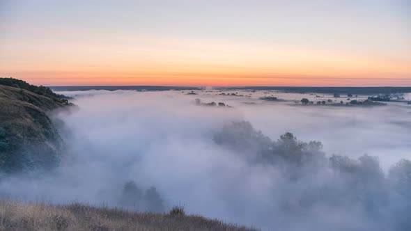 Timelapse Mist Curling Over River and Meadow on Sunrise Background alt