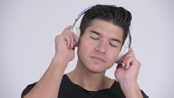 Face of Young Handsome Multi-ethnic Man Listening To Music alt