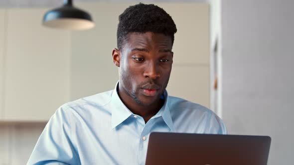 Young man communicating via video call using computer alt