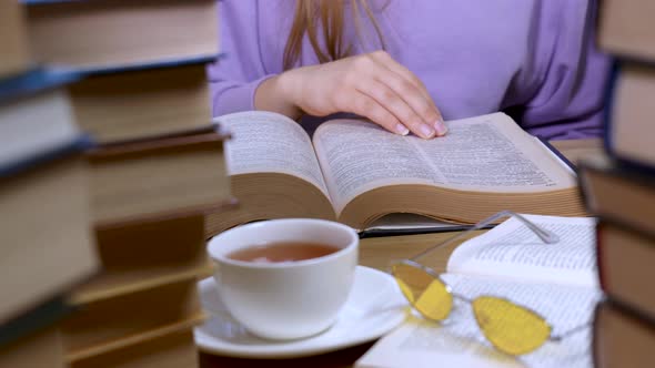 Female Hand Flipping Through the Pages of a Book Closeup alt