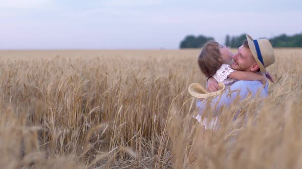 Happy Meeting, Little Cute Girl Hugging Happy Man on Wheat Field During the Harvest Season Against alt