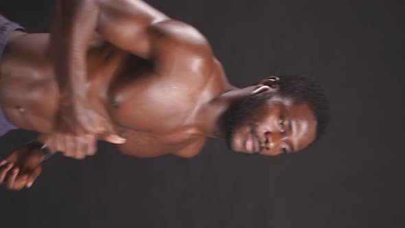 Slow Movement of a Muscular Man Engaged in Athletics Running Cardio Training on an Isolated alt