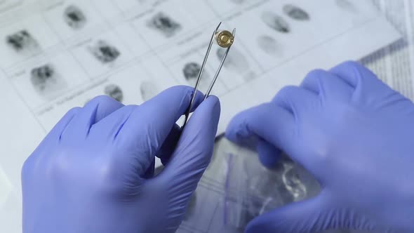 Criminology Expert Examining Weapon Bullet in Police Office Collecting Evidence alt