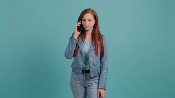 Portrait of Happy Young Woman Having a Pleasant Mobile Conversation alt