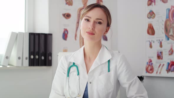 Handheld video shows of female doctor sitting in her office. Shot with RED helium camera in 8K alt