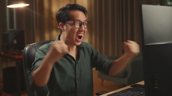 Asian Male Works His Personal Computer And Celebrating, He Works At Night alt