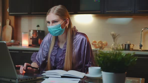 Young Business Woman in Protective Mask Working at Home on Quarantine alt