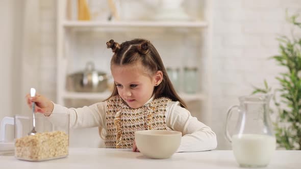 Child Put Cereal in a Bowl