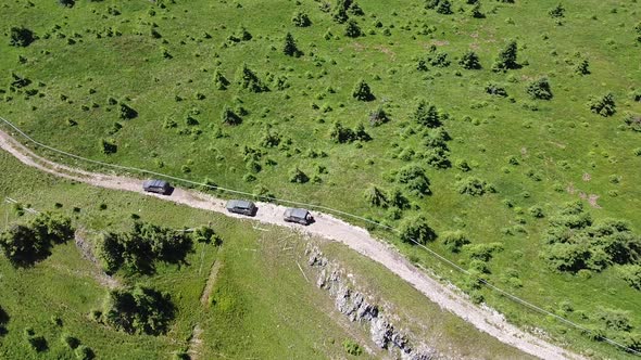 Road In Mountains With Off Road Cars