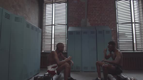 Afro-American Boxers Wrapping Wrists in Locker Room and Talking alt