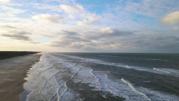 Aerial view of rolling waves and sunrise at the ocean close to Løkken by the North Sea, Denmark alt