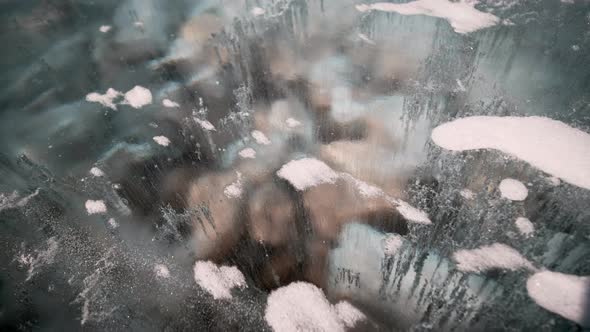 Bubbles Frozen in Clear Teal Ice with Shallow Rocks, Slow Dolly Tight Day Outdoor. Air Trapped in Wi alt