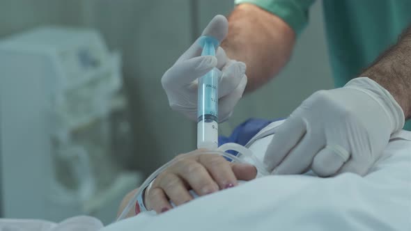 Doctor gives the patient anesthesia before the operation