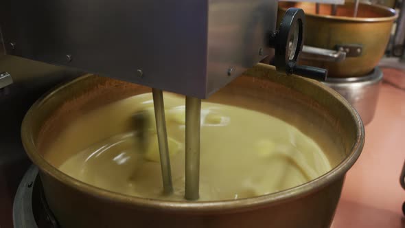 Mixing ingredients for chocolate fudge at candy factory