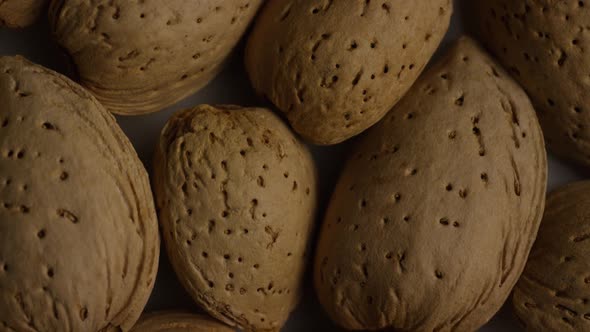 Cinematic, rotating shot of almonds on a white surface - ALMONDS alt