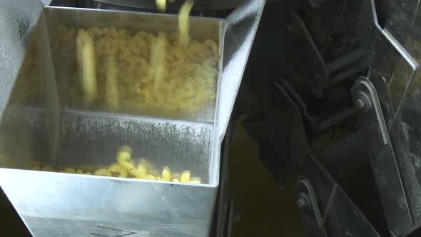 Macaroni Falling Down in a La Carte Machine