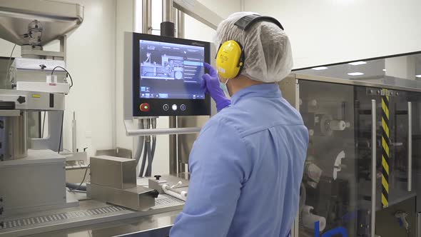 Pharmacist Control Pharmaceutical Manufacturing Process at Drug Factory Using Touchscreen Computer alt