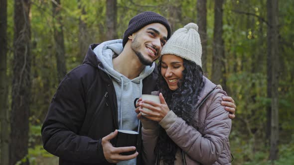 Young Couple in Love Stand in Embrace in Nature Drinking Tea Communicate Enjoy Romantic Date Happy alt