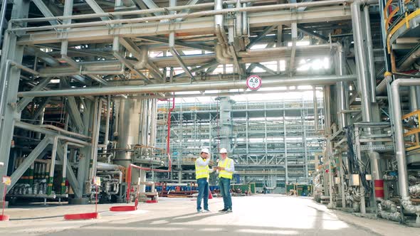 Petroleum Refinery Factory with Two Workers Talking alt