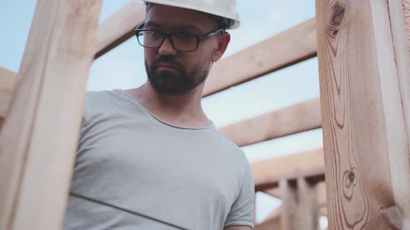 Civil Engineer Takes Measurements at a Construction Site, From Below alt