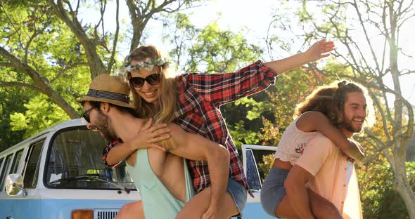 Hipster boys carrying girls on their shoulders alt