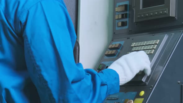 close up hand finger press button controling cnc machine alt