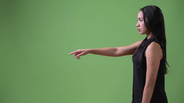 Profile View of Young Beautiful Asian Businesswoman Pointing Finger alt