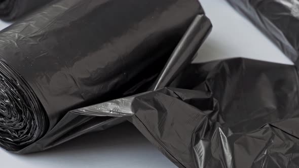 New black garbage bags on a white background.