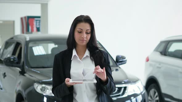 Attractive Elegant Business Lady Using Laptop with a Graphic Image of the Inscription CAR