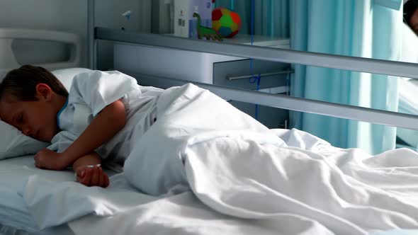 Patients resting with teddy bear on bed alt