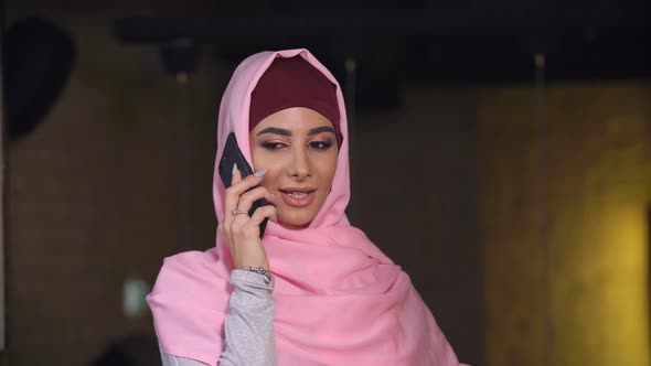 Attractive Muslim Woman Talking at Mobile Phone