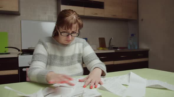 Woman Examines the Purchases Made and the Prices at Home Shopping Spends a Lot of Money alt