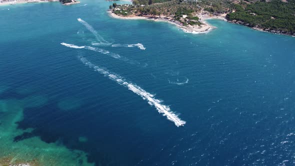 Aerial View Over Man Speeding On Jet Ski Tourist Attraction Exotic Tropical Island Shore Beach At