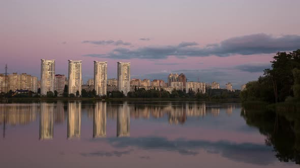 High Rise Buildings Of A Big City Near A Calm River, Timelapse